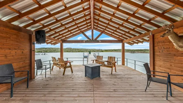 an aerial view of residential houses with outdoor space and trees all around