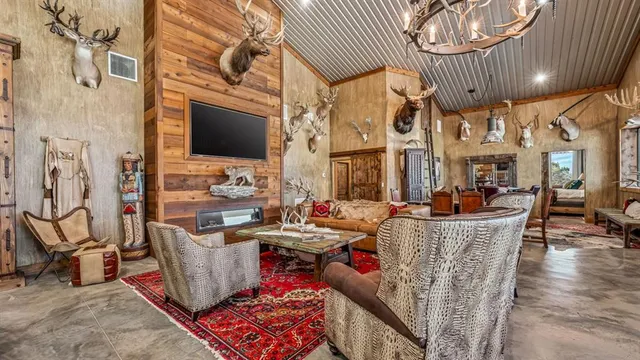 a living room with fireplace furniture and a wooden floor