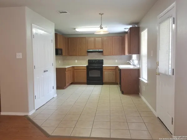 a large kitchen with cabinets and stainless steel appliances