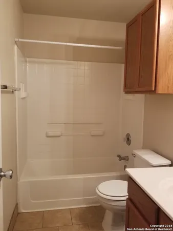 a bathroom with a sink a toilet and mirror