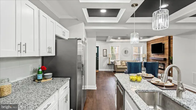 a kitchen with stainless steel appliances granite countertop a sink refrigerator and microwave