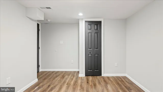 a view of hallway with wooden floor