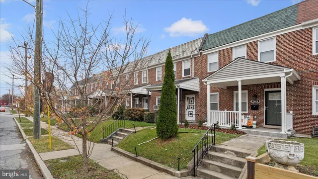 a view of a deck with couches chairs and wooden fence