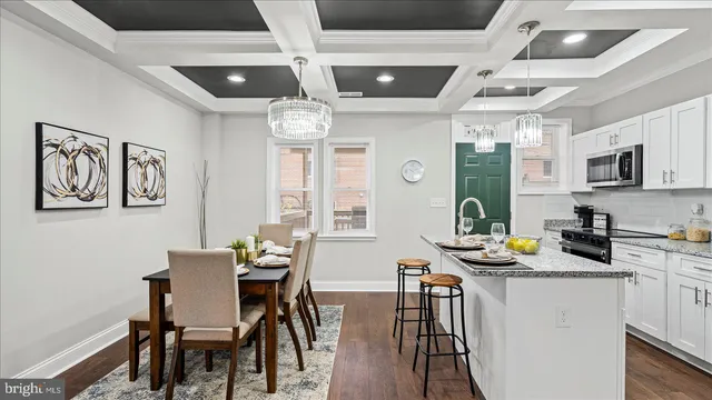 a view of a dining room with furniture a chandelier and wooden floor