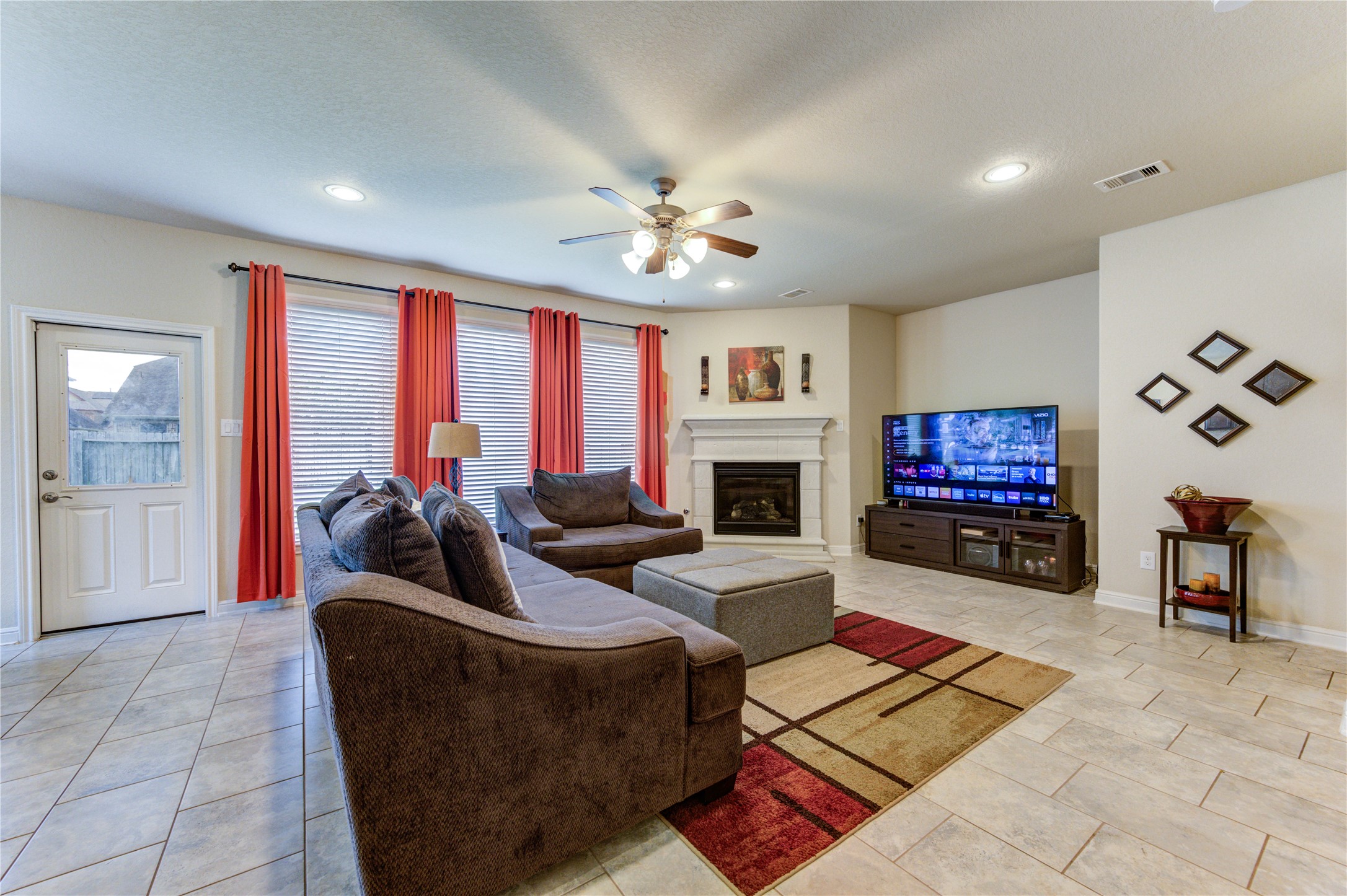 24511 Stratton Creek Drive Spring, TX 77373 - Photo 7 of 27 Relax and unwind in the inviting family room centered around a warm gas fireplace, adding comfort and charm throughout the seasons.