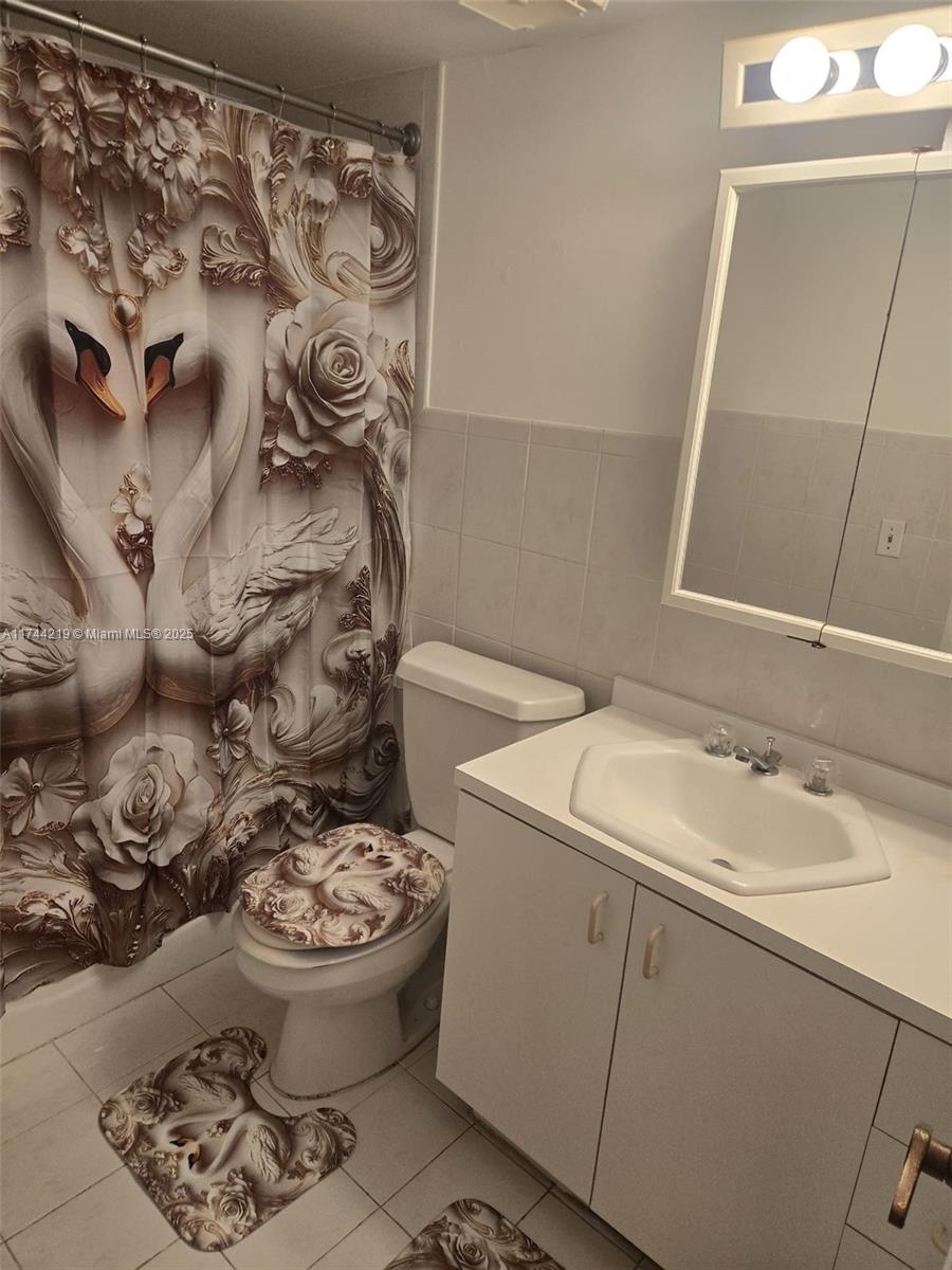 5201 Northwest 7th Street, Unit 403 Miami, FL 33126 - Photo 3 of 5 a bathroom with a sink and toilet