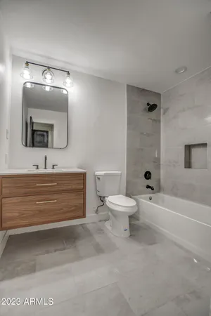 a bathroom with a toilet a sink and bathtub