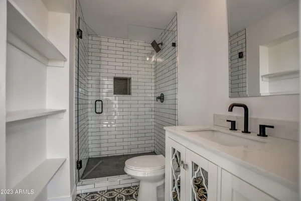 a bathroom with a sink toilet and shower