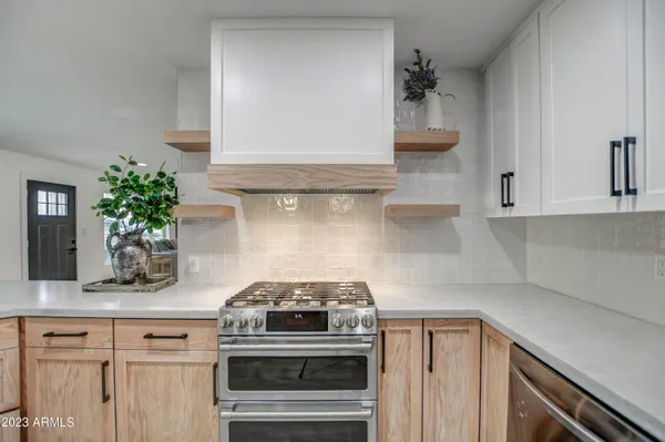 a kitchen with a stove and cabinets
