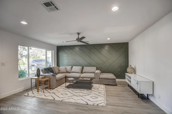 a living room with furniture and a large window