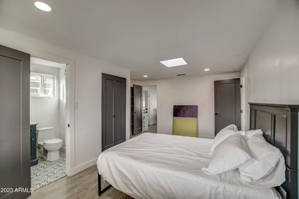 a bedroom with a bed and a lamp