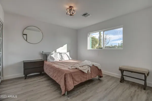 a bedroom with a bed and a workspace