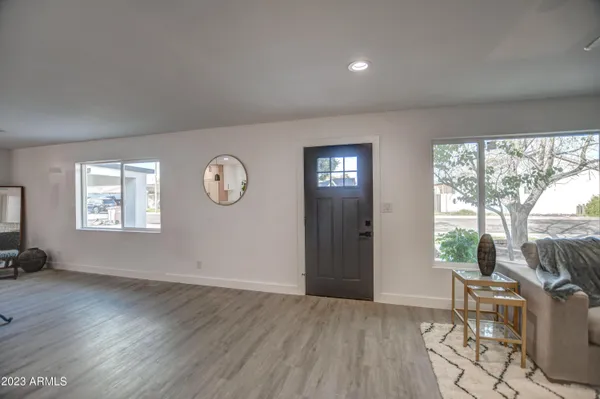 a view of a living room and kitchen with wooden floor