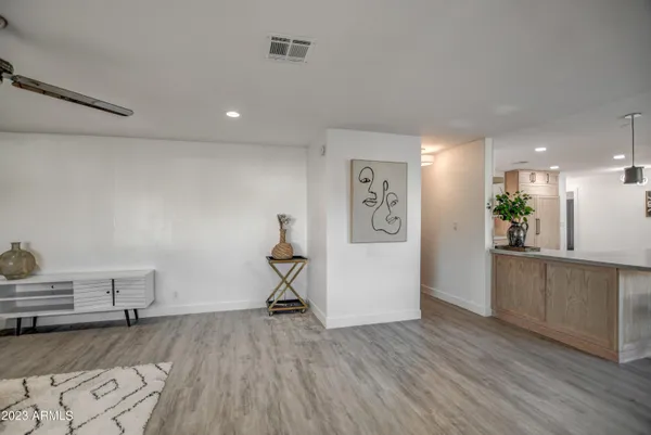 a view of a kitchen with cabinets stainless steel appliances a sink and a counter top space