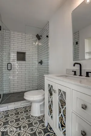 a spacious bedroom with a bed and wooden floor