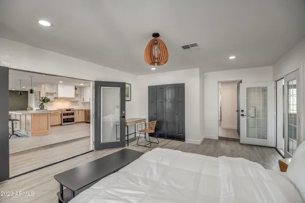 a kitchen with a dining table chairs sink and white cabinets