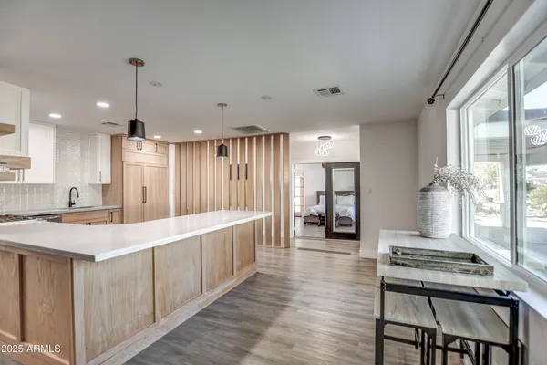 a large white kitchen with a large window