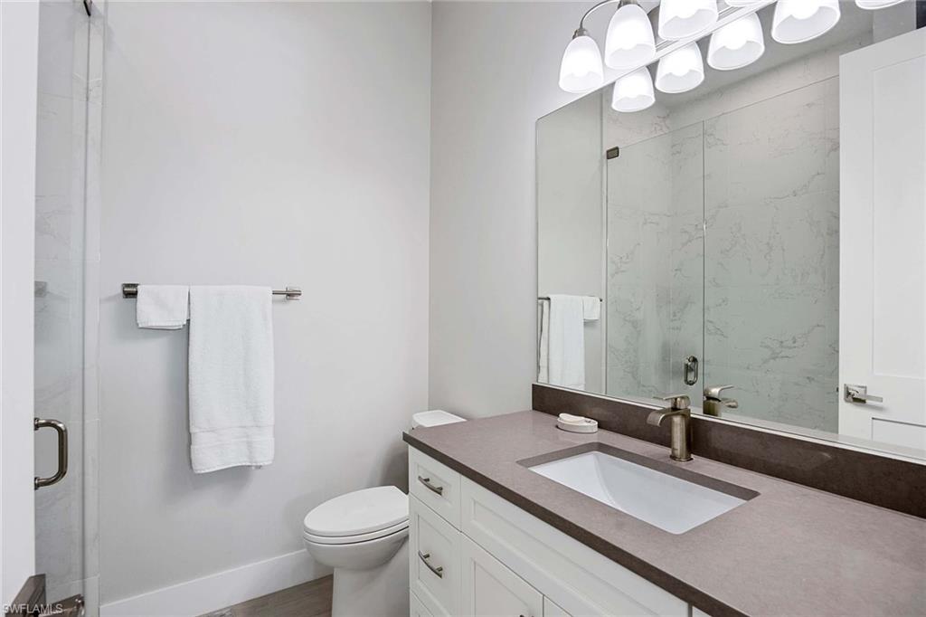1395 Curlew Avenue, Unit 43 Naples, FL 34102 - Photo 12 of 24 a bathroom with a sink a toilet and a mirror