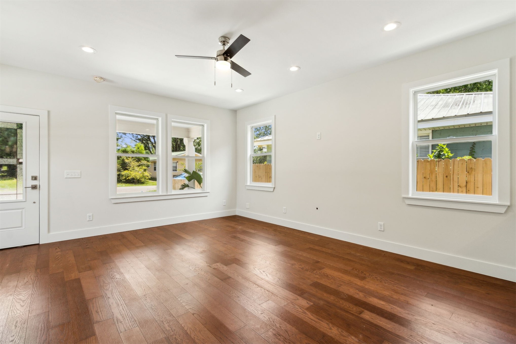 929 South 9th Street Fernandina Beach, FL 32034 - Photo 12 of 36 a view of an empty room with window and wooden floor