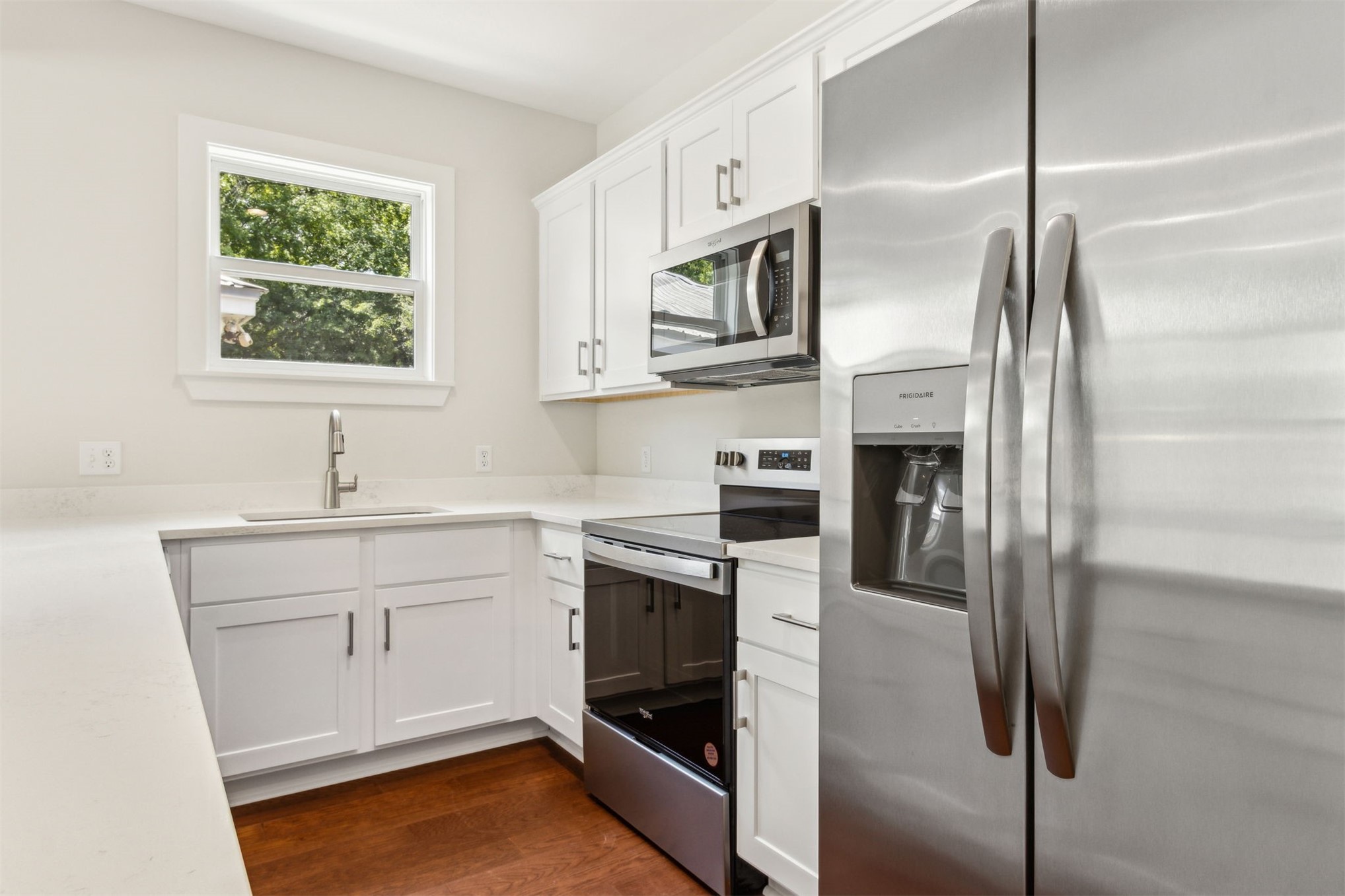 929 South 9th Street Fernandina Beach, FL 32034 - Photo 18 of 36 a kitchen with stainless steel appliances a refrigerator sink and white cabinets