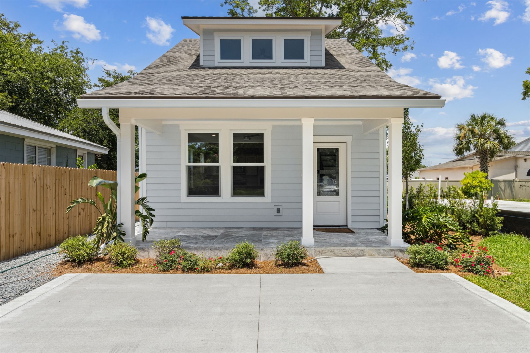 929 South 9th Street Fernandina Beach, FL 32034 - Photo 2 of 36 a front view of a house with a yard and garage