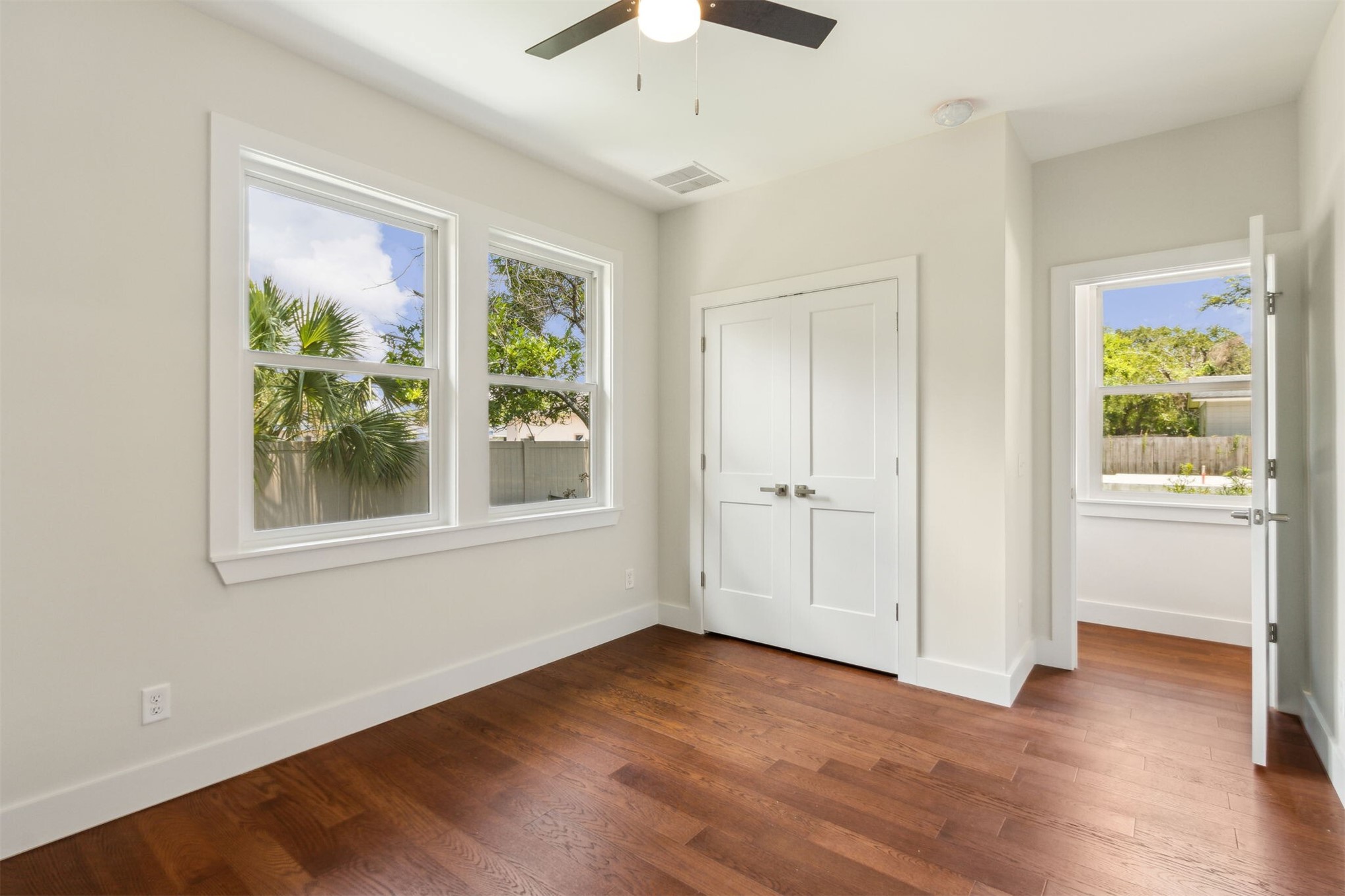 929 South 9th Street Fernandina Beach, FL 32034 - Photo 21 of 36 a view of an empty room with wooden floor and a window
