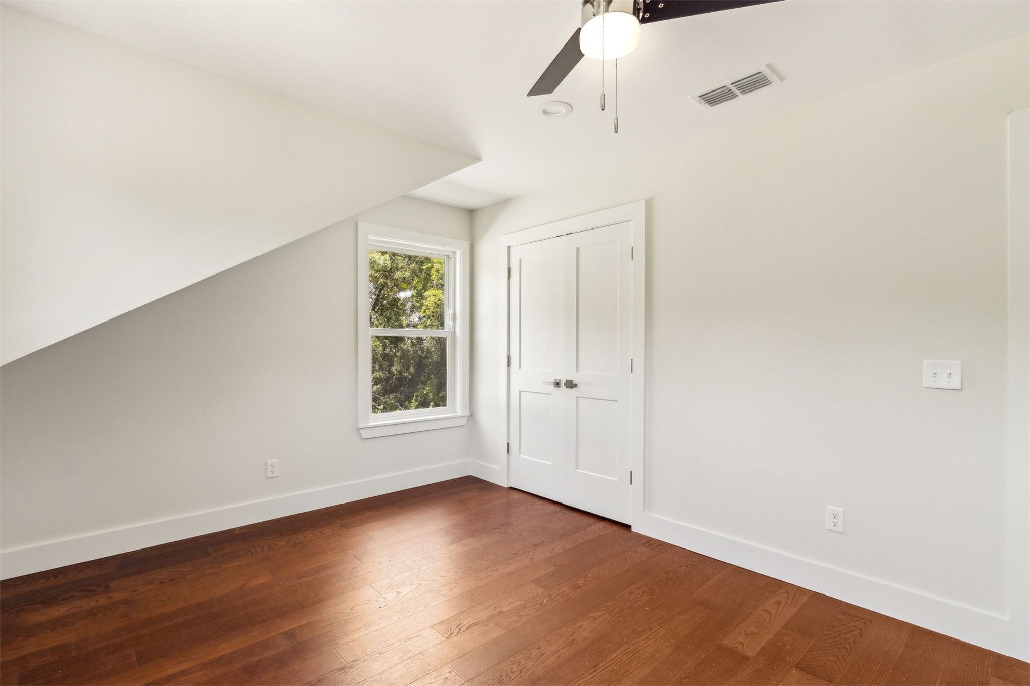 929 South 9th Street Fernandina Beach, FL 32034 - Photo 26 of 36 a view of an empty room with wooden floor and a window