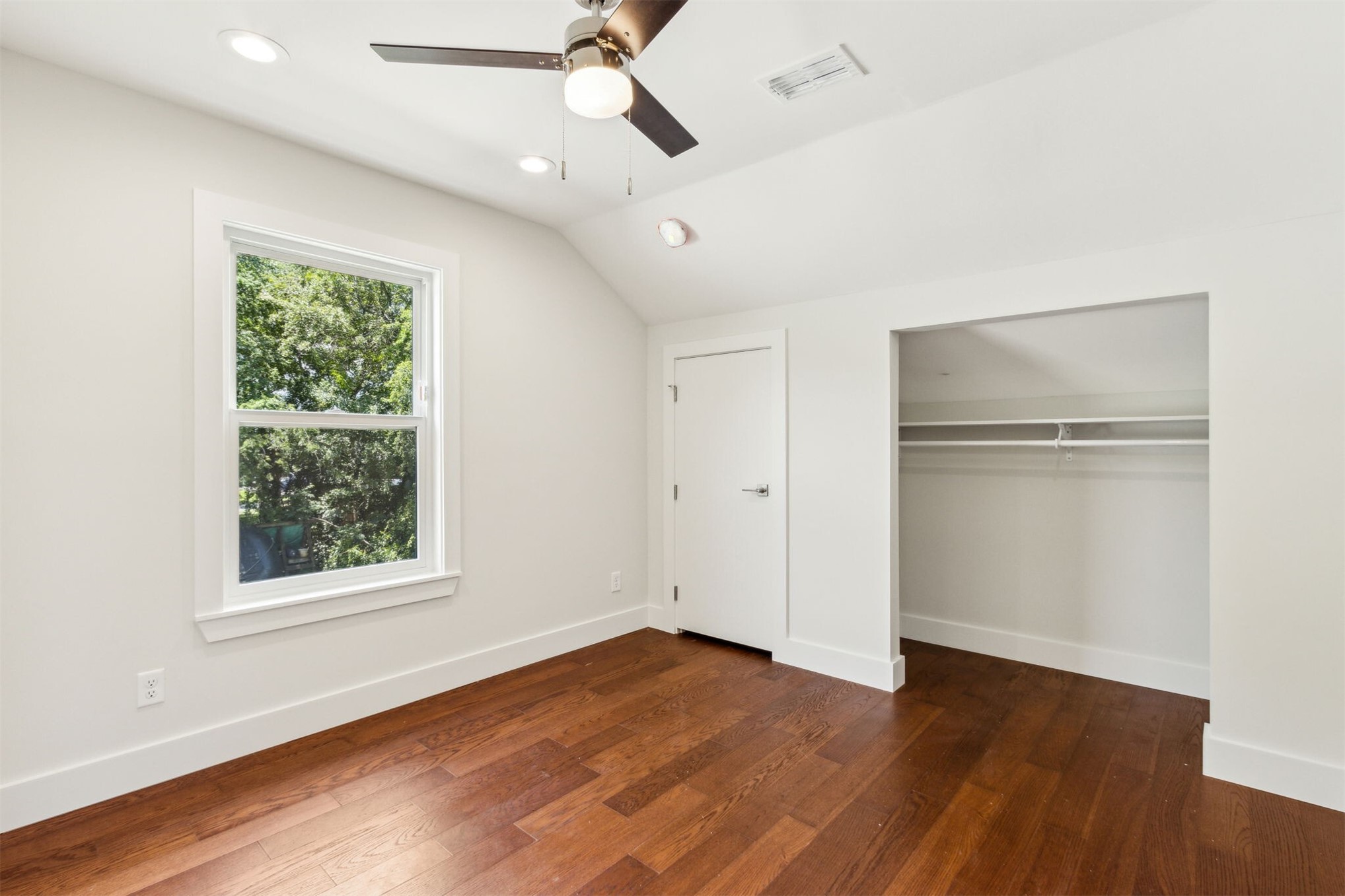 929 South 9th Street Fernandina Beach, FL 32034 - Photo 29 of 36 a view of an empty room with wooden floor and a window