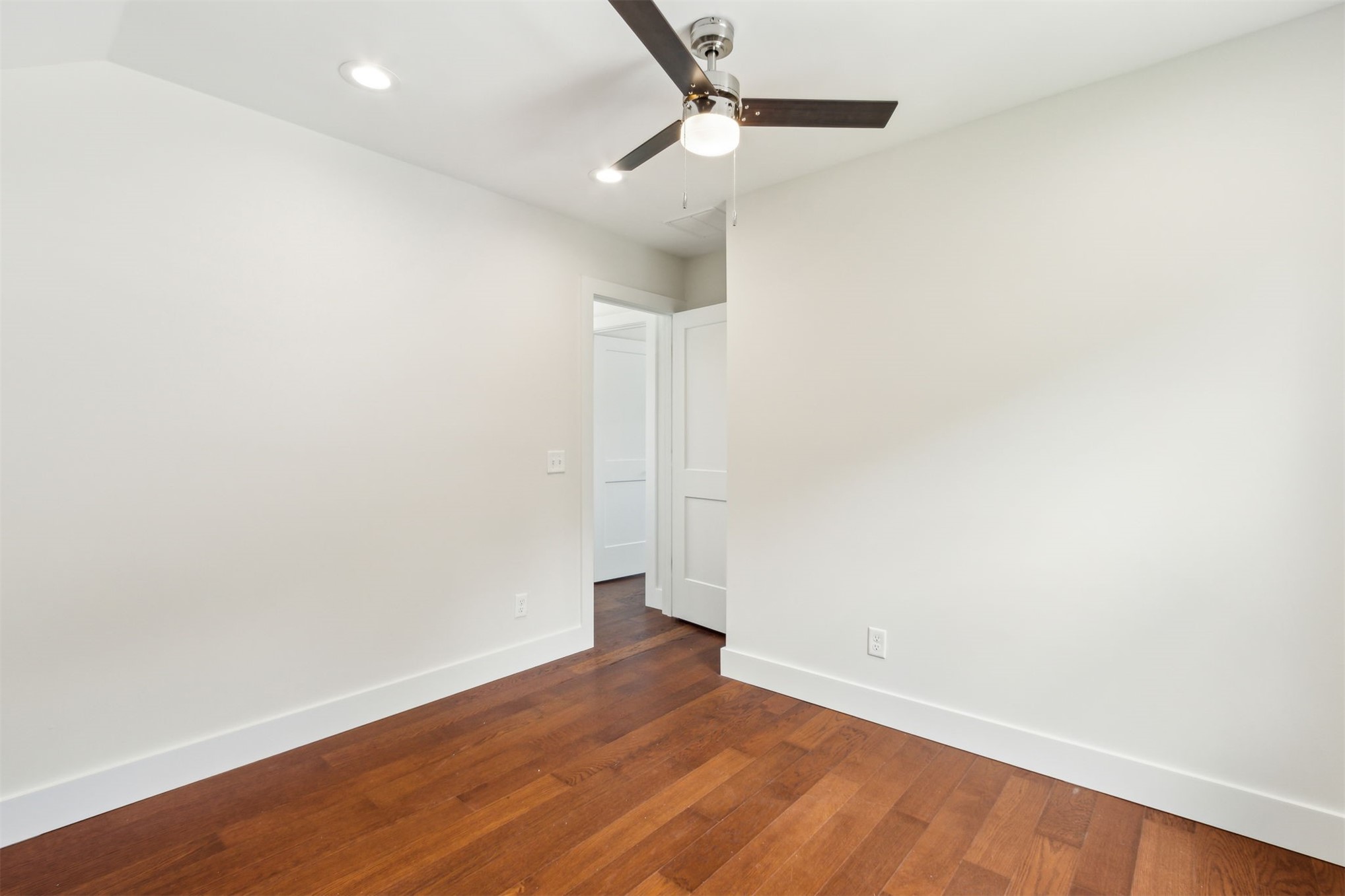 929 South 9th Street Fernandina Beach, FL 32034 - Photo 30 of 36 an empty room with wooden floor and fan