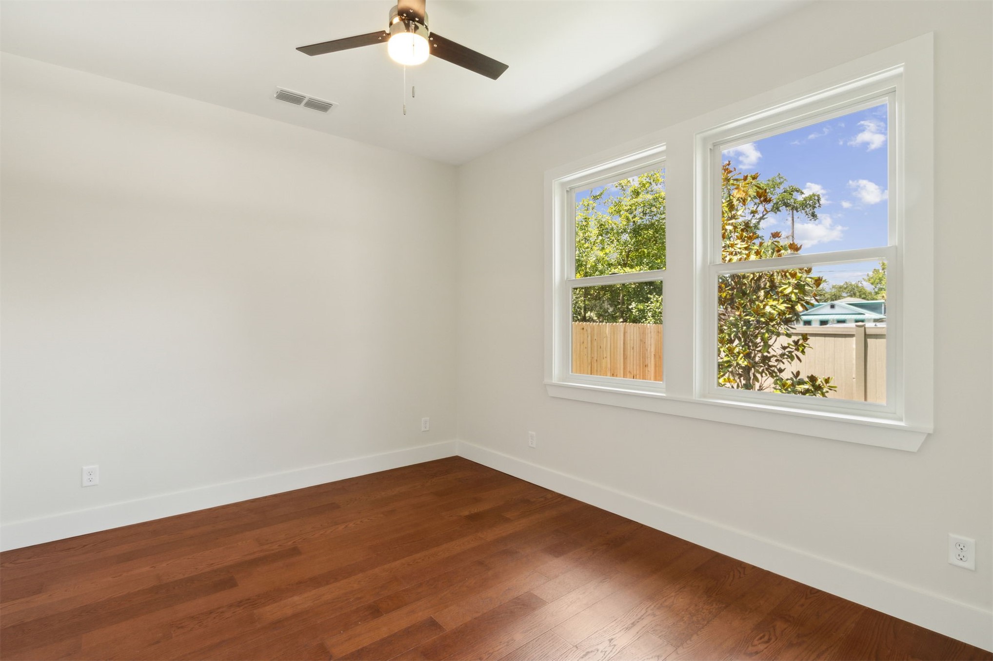 929 South 9th Street Fernandina Beach, FL 32034 - Photo 31 of 36 a view of an empty room with wooden floor and a window