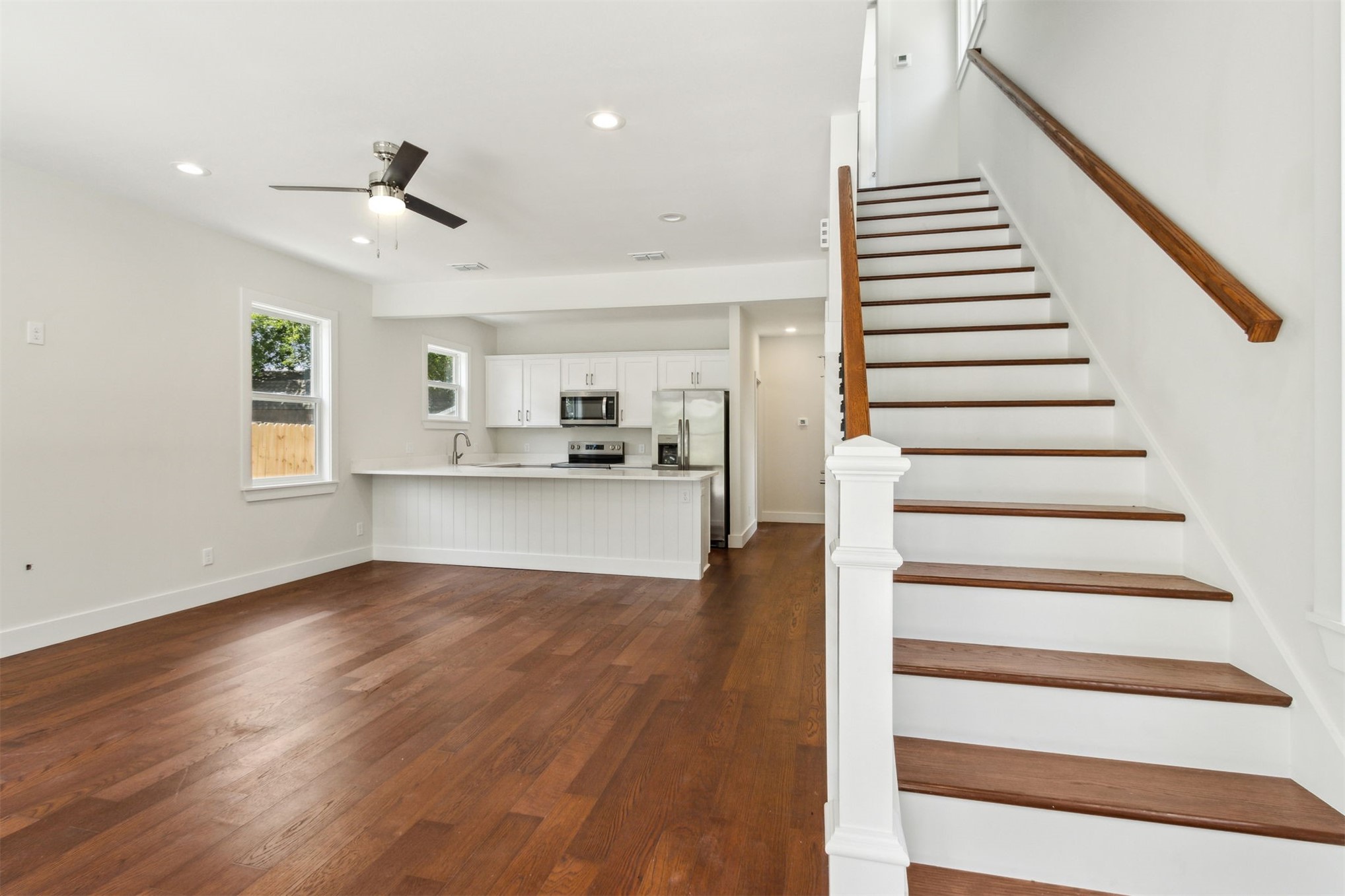 929 South 9th Street Fernandina Beach, FL 32034 - Photo 10 of 36 a view of a kitchen with wooden floor electronic appliances and stairs