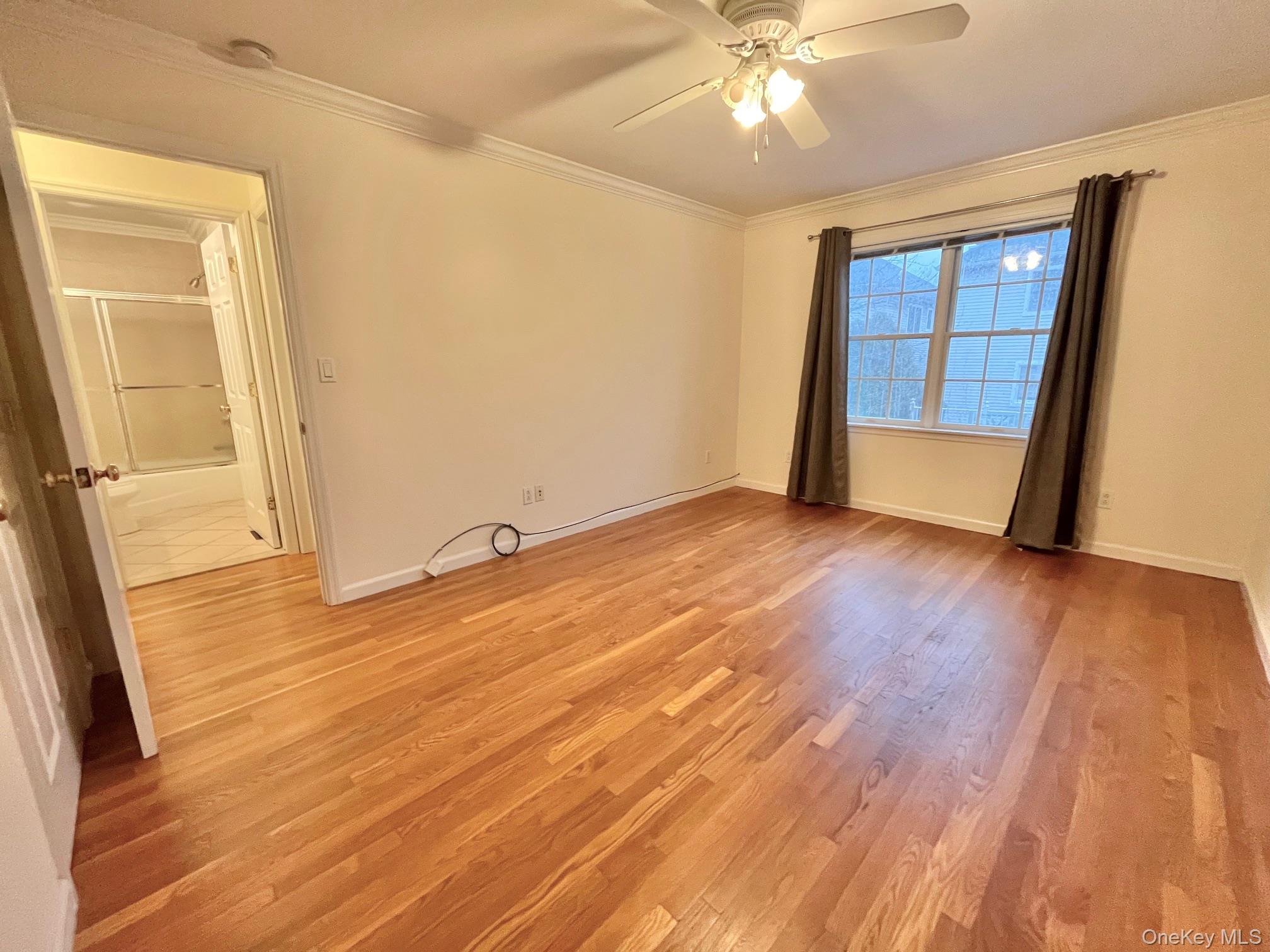 153 Montgomery Avenue, Unit B Scarsdale, NY 10583 - Photo 8 of 14 a view of an empty room with wooden floor and a window
