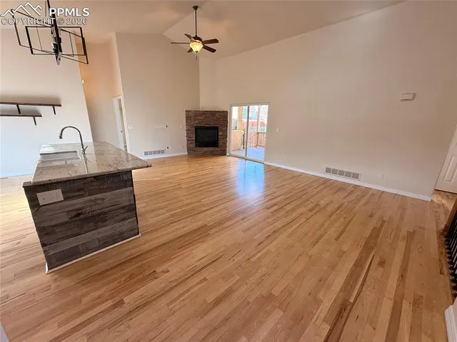 a kitchen with kitchen island a counter top space wooden floor and stainless steel appliances