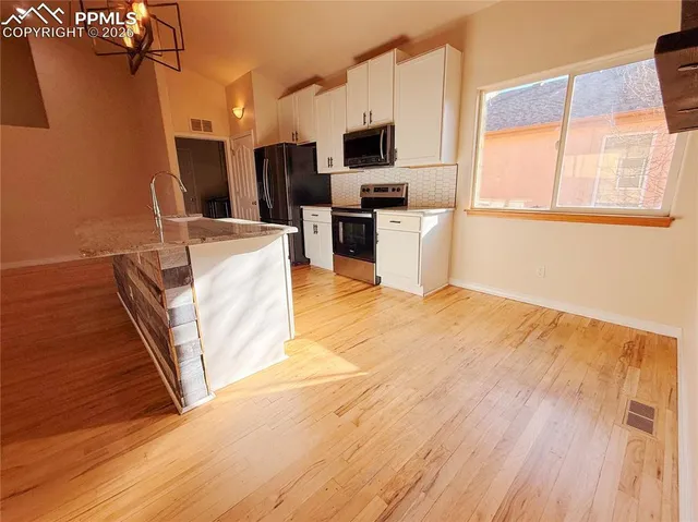 a kitchen with a stove and a refrigerator