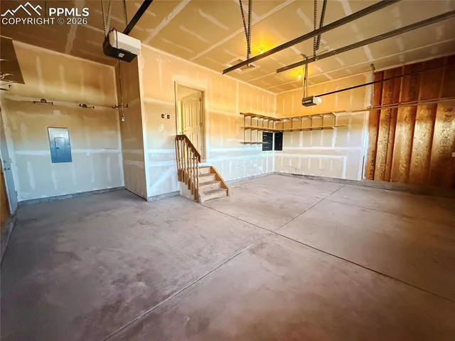 a view of empty room with wooden floor and fireplace