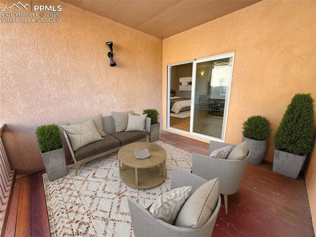 an empty room with wooden floor and a ceiling fan