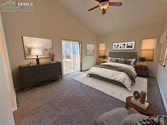 a view of a room with a ceiling fan and window