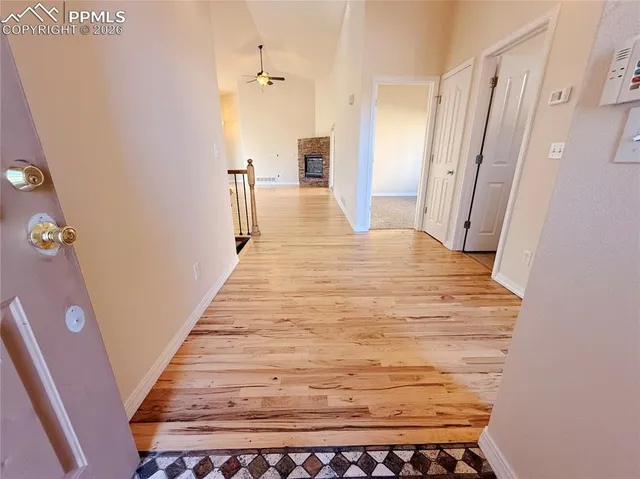 a view of a hallway with wooden floor and staircase