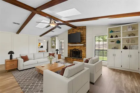 a living room with fireplace furniture and a rug