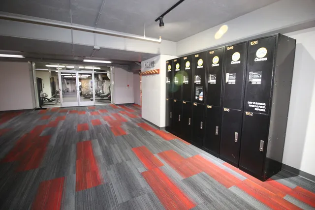 a room with lots of wooden furniture and windows