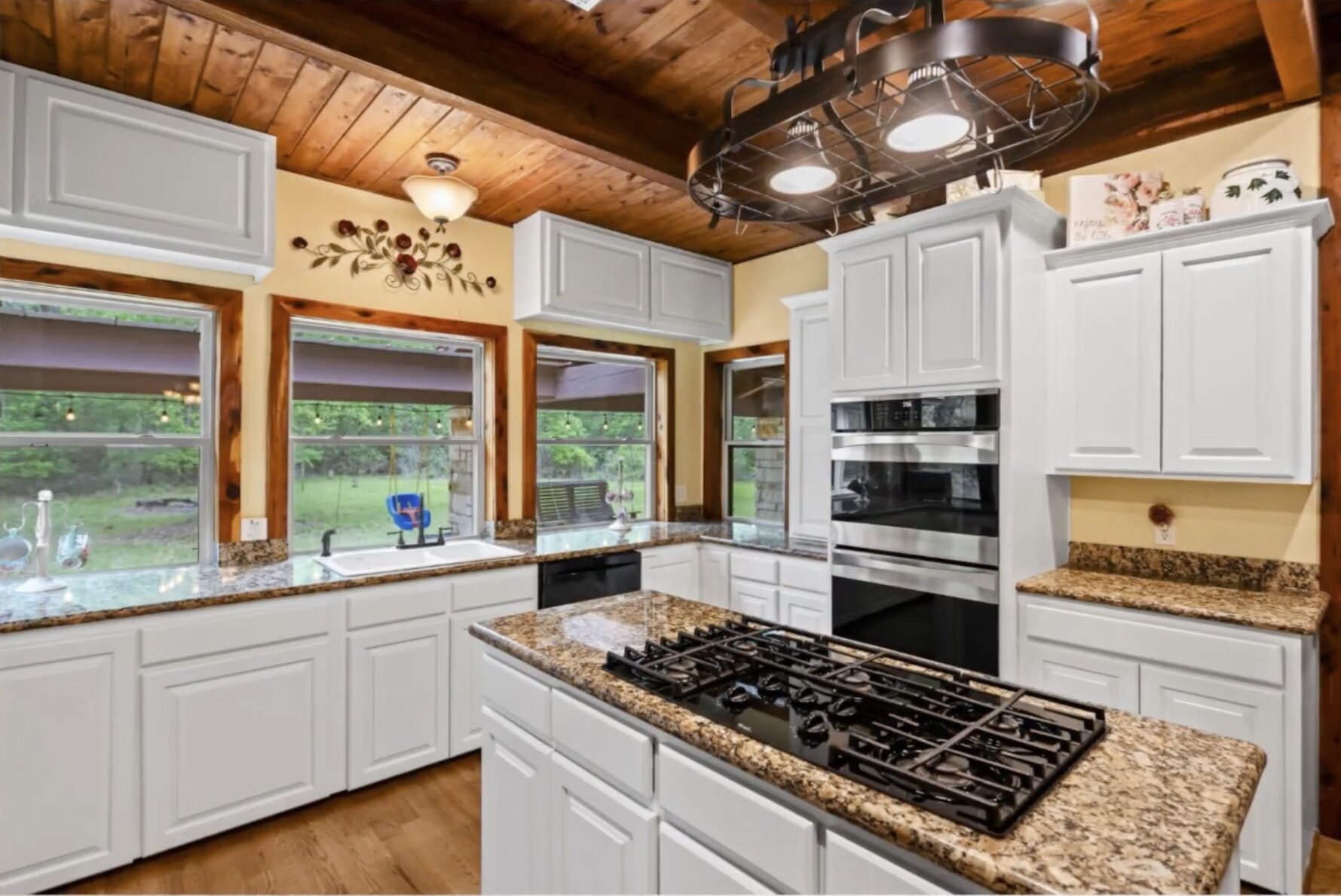 30338 Riley Road Waller, TX 77484 - Photo 12 of 46 a kitchen with stainless steel appliances a stove a sink and white cabinets