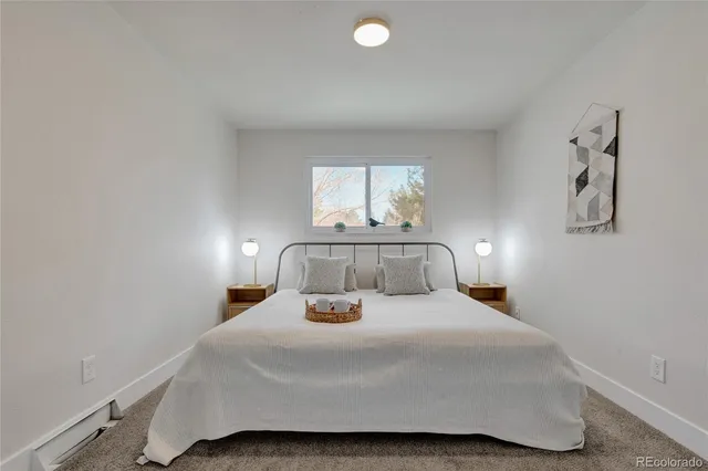 a bedroom with a bed and a night stand