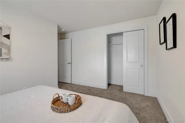 a bedroom with a bed and a wall painting