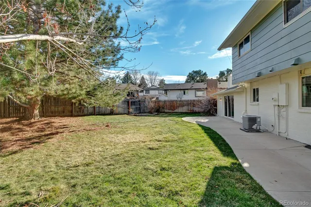 a swimming pool with yard and outdoor seating