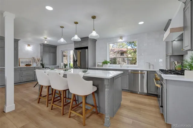 a kitchen with a dining table chairs sink and cabinets