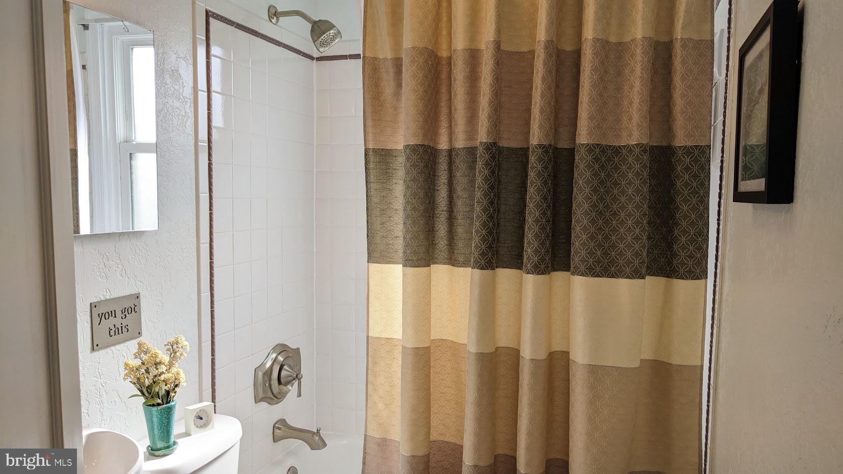 2903 Church Road Parkville, MD 21234 - Photo 17 of 37 a bathroom with a shower curtain and a sink