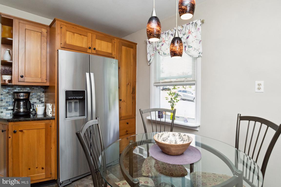 2903 Church Road Parkville, MD 21234 - Photo 9 of 37 a kitchen with stainless steel appliances a refrigerator and a dining table