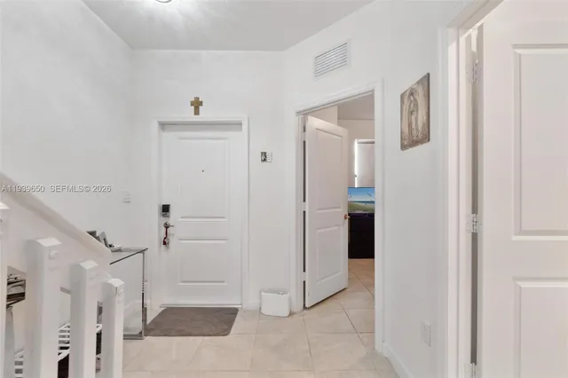 a view of a hallway with closet and cabinet