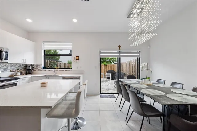 a view of a dining room with furniture and chandelier