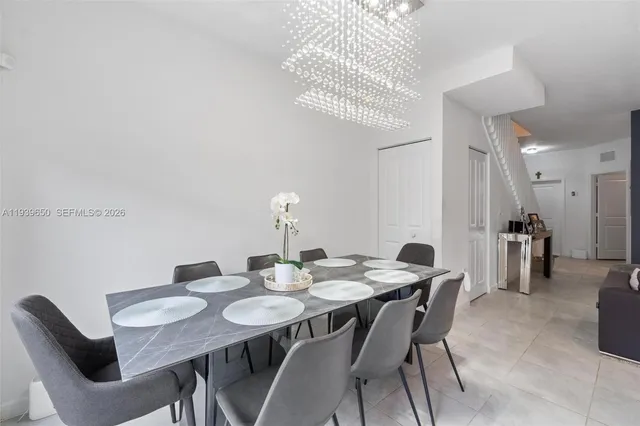 a dining room with furniture and a chandelier